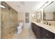Elegant bathroom with double sinks, custom vanities, and a glass-enclosed shower at 6615 E Shea Blvd, Scottsdale, AZ 85254