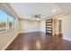 Bright bedroom featuring wood-look floors and an ensuite bath accessed via modern barn door at 6615 E Shea Blvd, Scottsdale, AZ 85254