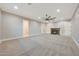 Large bonus room featuring a ceiling fan and a fireplace at 6615 E Shea Blvd, Scottsdale, AZ 85254