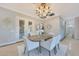 Elegant dining area with stylish chandelier and views of the outdoor patio at 6615 E Shea Blvd, Scottsdale, AZ 85254