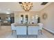 Formal dining room featuring modern lighting and easy access to the kitchen and backyard at 6615 E Shea Blvd, Scottsdale, AZ 85254