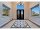 Bright entryway featuring marble floors, a decorative tile design, and views to the front yard through large windows at 6615 E Shea Blvd, Scottsdale, AZ 85254