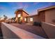 Charming exterior with stone accents, a private patio, and beautiful architectural details for outdoor enjoyment at 6615 E Shea Blvd, Scottsdale, AZ 85254