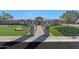 Stunning single-story home featuring manicured landscaping, stone accents, and a beautiful brick pathway to the front door at 6615 E Shea Blvd, Scottsdale, AZ 85254