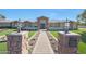 Beautiful single-story home with a brick walkway leading to the entrance, flanked by well-manicured lawns at 6615 E Shea Blvd, Scottsdale, AZ 85254