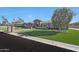 Stunning single-story home featuring manicured landscaping, stone accents, and a beautiful lawn at 6615 E Shea Blvd, Scottsdale, AZ 85254
