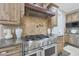 Close-up of chef's kitchen with stainless steel stove and hood at 6615 E Shea Blvd, Scottsdale, AZ 85254