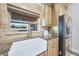 Kitchen featuring a farmhouse sink, stainless steel refrigerator, and beautiful natural lighting at 6615 E Shea Blvd, Scottsdale, AZ 85254