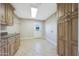 Laundry room featuring wooden cabinets, a sink, and a backyard view at 6615 E Shea Blvd, Scottsdale, AZ 85254