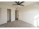 Bedroom with carpet, ceiling fan, closet, and white walls at 6808 W Sierra St, Peoria, AZ 85345