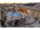 Backyard featuring a freeform pool with rock accents, a spa, and an outdoor living space at 7157 E Ivyglen Cir, Mesa, AZ 85207