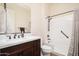Bathroom featuring a shower-tub combo, a single vanity sink, and neutral finishes at 7157 E Ivyglen Cir, Mesa, AZ 85207