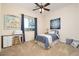 Cozy bedroom with natural light and a comfortable bed, perfect for relaxation at 7157 E Ivyglen Cir, Mesa, AZ 85207