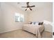 Bright bedroom with plush carpeting, a large window, and neutral décor at 7157 E Ivyglen Cir, Mesa, AZ 85207