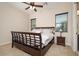 Well-lit bedroom with dark wood furniture, plush carpet, and ample natural light at 7157 E Ivyglen Cir, Mesa, AZ 85207