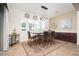 Dining area boasts decorative lighting, wainscotting, and backyard views at 7157 E Ivyglen Cir, Mesa, AZ 85207