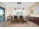 Dining area boasts decorative lighting, wainscotting, and backyard views at 7157 E Ivyglen Cir, Mesa, AZ 85207