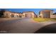 Expansive driveway leading to a three-car garage of a well-maintained home at 7157 E Ivyglen Cir, Mesa, AZ 85207