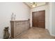 Elegant foyer featuring tile floors, a decorative sideboard, and double doors at 7157 E Ivyglen Cir, Mesa, AZ 85207