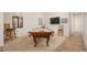 Spacious game room featuring a well-lit pool table and a cozy seating area at 7157 E Ivyglen Cir, Mesa, AZ 85207