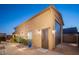 Oversized garage with an additional door and mature landscape on the side offers ample parking and curb appeal at 7157 E Ivyglen Cir, Mesa, AZ 85207