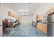 Large garage with epoxy flooring, built-in cabinets, and a sink provides ample storage and workspace for various activities at 7157 E Ivyglen Cir, Mesa, AZ 85207