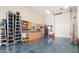 Well-equipped garage with epoxy floors, storage cabinets, and a sink offers a functional space for hobbies and storage at 7157 E Ivyglen Cir, Mesa, AZ 85207