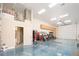 Oversized garage with epoxy flooring, loft storage, and bathroom offers ample space for vehicles, projects, and convenience at 7157 E Ivyglen Cir, Mesa, AZ 85207