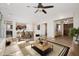 Spacious living room with a ceiling fan, a dining area and stylish furnishings at 7157 E Ivyglen Cir, Mesa, AZ 85207