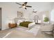 Serene main bedroom with soft lighting, carpet, ceiling fans and a sitting area at 7157 E Ivyglen Cir, Mesa, AZ 85207