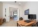 Bright office space with a desk, leather sofa and open doorway to the living room at 7157 E Ivyglen Cir, Mesa, AZ 85207