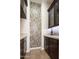 Pantry featuring custom mosaic tile accent, cabinets, and stone countertops at 7157 E Ivyglen Cir, Mesa, AZ 85207