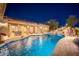 Luxurious backyard boasts a beautiful pool with rock features and patio, creating a perfect space for outdoor living and entertaining at 7157 E Ivyglen Cir, Mesa, AZ 85207