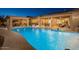 Resort-style pool with a covered patio and ample seating offers an ideal setting for relaxation and outdoor gatherings at 7157 E Ivyglen Cir, Mesa, AZ 85207