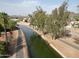 Aerial view showcasing a serene canal lined with trees, with residential area at 750 E Northern Ave # 1079, Phoenix, AZ 85020