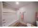 Bright bathroom with a white tiled shower-tub, decorative rug, and neutral-colored walls at 750 E Northern Ave # 1079, Phoenix, AZ 85020