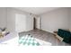 Neutral bedroom with wood-look floors, green and white rug, and bright natural light at 750 E Northern Ave # 1079, Phoenix, AZ 85020