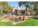 Community clubhouse featuring a decorative fountain, manicured lawn, and desert landscaping at 750 E Northern Ave # 1079, Phoenix, AZ 85020