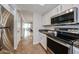 View of kitchen with stainless steel appliances and granite countertops leading to an adjacent room at 750 E Northern Ave # 1079, Phoenix, AZ 85020