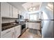 Bright kitchen featuring white cabinetry, stainless steel appliances, and granite countertops at 750 E Northern Ave # 1079, Phoenix, AZ 85020