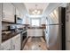 Well-lit kitchen with stainless steel appliances, granite countertops, and white cabinetry at 750 E Northern Ave # 1079, Phoenix, AZ 85020