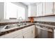 Close-up of kitchen with stainless steel appliances, granite countertops, sink, and white cabinetry at 750 E Northern Ave # 1079, Phoenix, AZ 85020