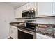 Close-up of kitchen with stainless steel appliances and granite countertops at 750 E Northern Ave # 1079, Phoenix, AZ 85020