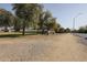 Gravel area showing trees, a grassy area, and neighborhood homes at 750 E Northern Ave # 1079, Phoenix, AZ 85020
