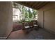Covered patio with tile floors, two chairs and courtyard views at 750 E Northern Ave # 1079, Phoenix, AZ 85020
