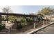 Exterior shot of a restaurant with hanging lights, lush greenery, and rustic charm at 750 E Northern Ave # 1079, Phoenix, AZ 85020