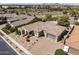 Expansive aerial view of a desert home with a red tiled roof and a spacious driveway at 7576 W Quail Ave, Glendale, AZ 85308