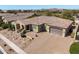 Desert home showcasing a red tiled roof, beautiful landscaping, and an expansive driveway at 7576 W Quail Ave, Glendale, AZ 85308