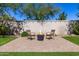 Landscaped backyard featuring a cozy seating area with a fire pit and string lights at 7576 W Quail Ave, Glendale, AZ 85308