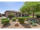 Lush backyard featuring artificial grass, mature trees, and desert landscaping, creating a private and serene oasis at 7576 W Quail Ave, Glendale, AZ 85308